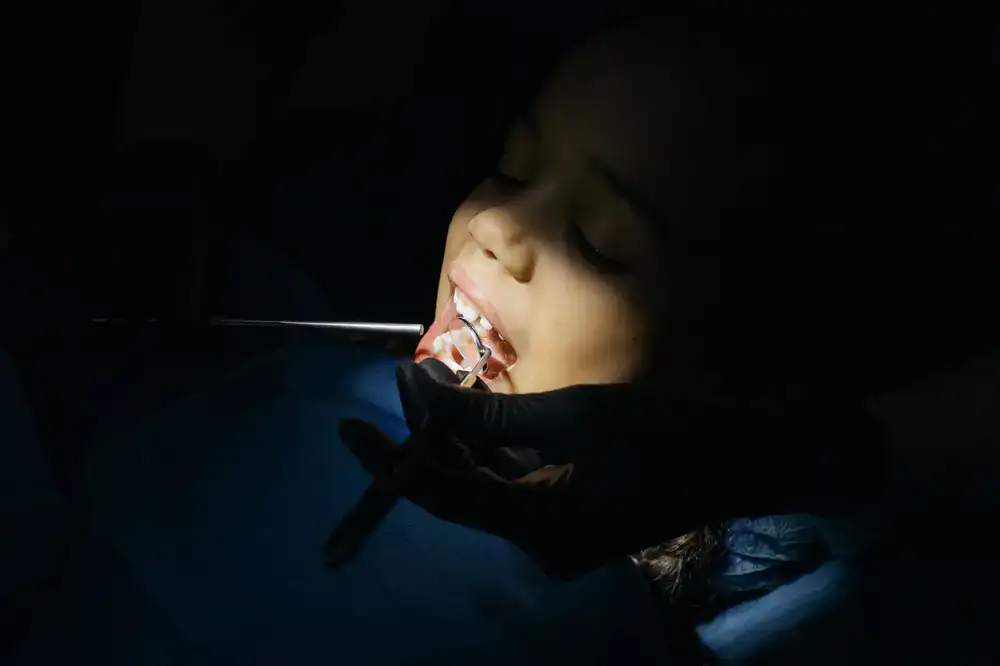 Dentist gently examining a child's teeth
